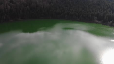 Aerial-view-of-Sfanta-Ana-Lake-in-Romania,-volcanic-lake-with-beautiful-green-water