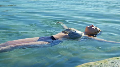 woman swimming in the water at beach 4k