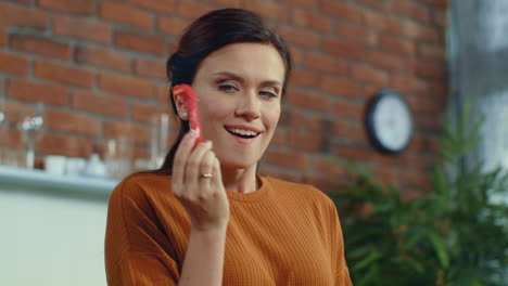 woman tasting slice of red paprika