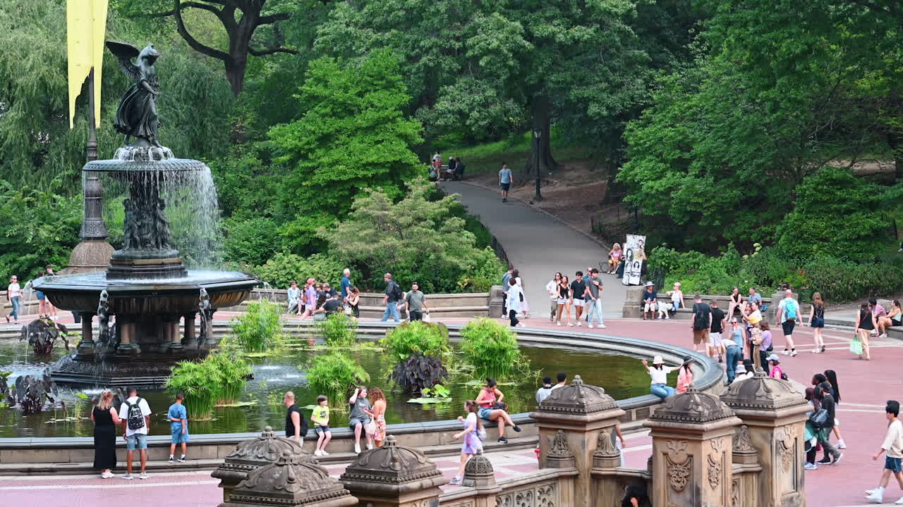 New York, USA, 28 July 2025: Visitors at bethesda terrace. People stroll around Bethesda Fountain while greenery surrounds the iconic terrace in Central Park, Manhattan