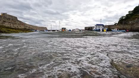 waves crashing near docked boat in dysart