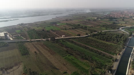 Aerial-shot-for-The-River-Nile-of-Egypt-surrounded-by-the-green-lands-of-the-Nile-Valley