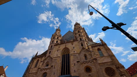 vienna, austria - june 9, 2025: wien's stunning blue skies. tourists admire stunning architecture in wien, austria, with detailed gothic towers reaching towards the clouds