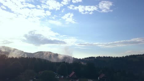 Establishing-Aerial-Drone-Shot-of-Romanian-Mountains-Revealing-a-Festival-and-Campground