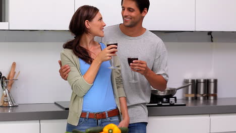 Couple-chatting-and-toasting-in-the-kitchen