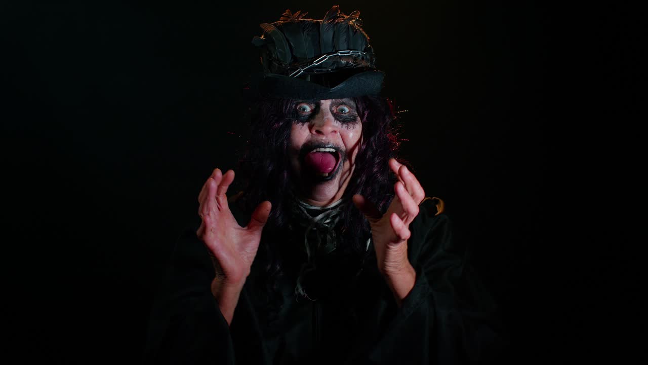 Sinister old woman in Halloween witch costume screams from stress problems feels horror hopelessness