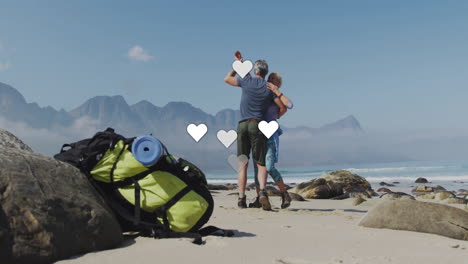 man and woman dancing on seaside beach, showcasing health tracker graph floating above backpack