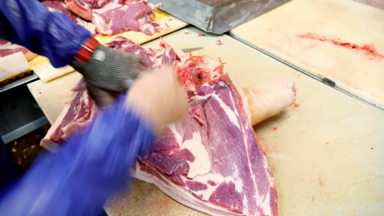 Butcher preparing pork cuts