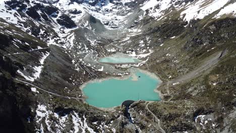 breathtaking view of a turquoise-green mountain lake with a glacier in the background, sunny weather with blue skies