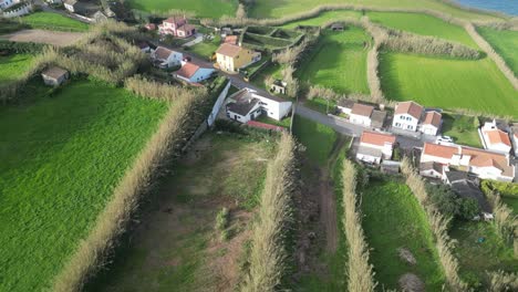 Azores-from-drone-view,-early-sunny-morning-with-view-of-houses-surrounded-by-fields