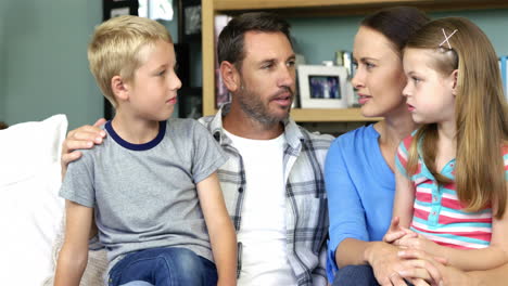 cute family talking sitting on the couch