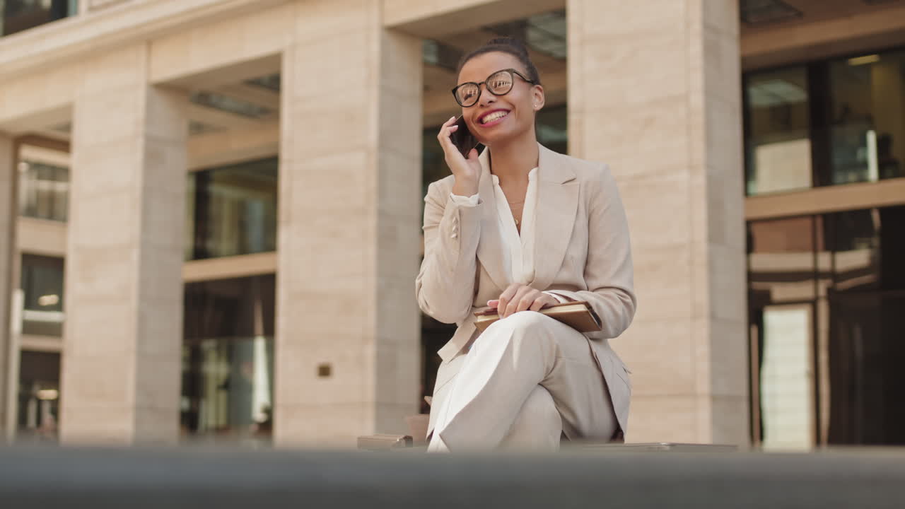 Cheerful Businesswoman Talking on Mobile Phone Outdoors