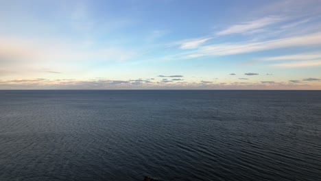 flying over cliffs near portland, maine to view the atlantic ocean at sunset, aerial view