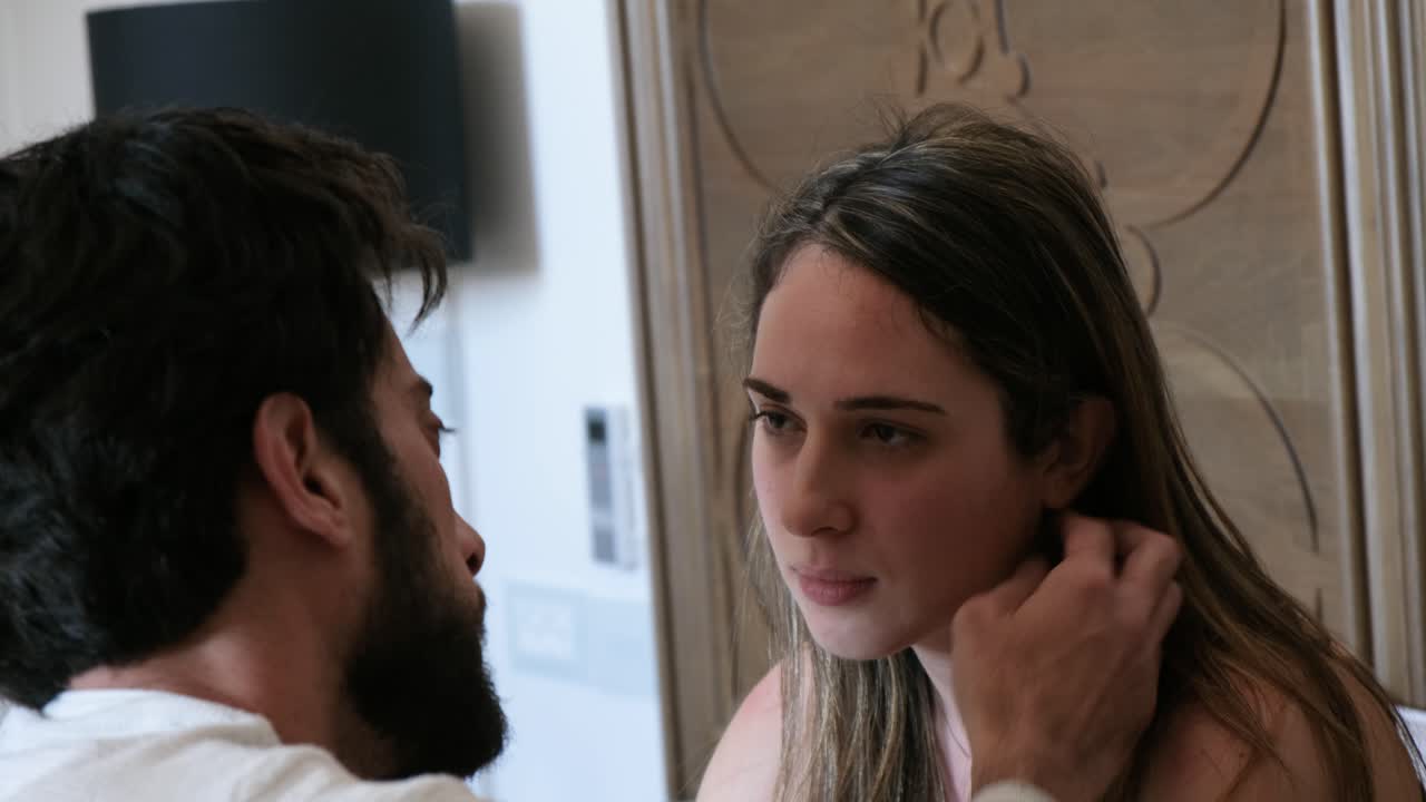 sad Couple Having An intimate Moment of love, Looking into each others eyes in bed.