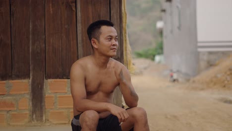 man sitting outdoors in rural area