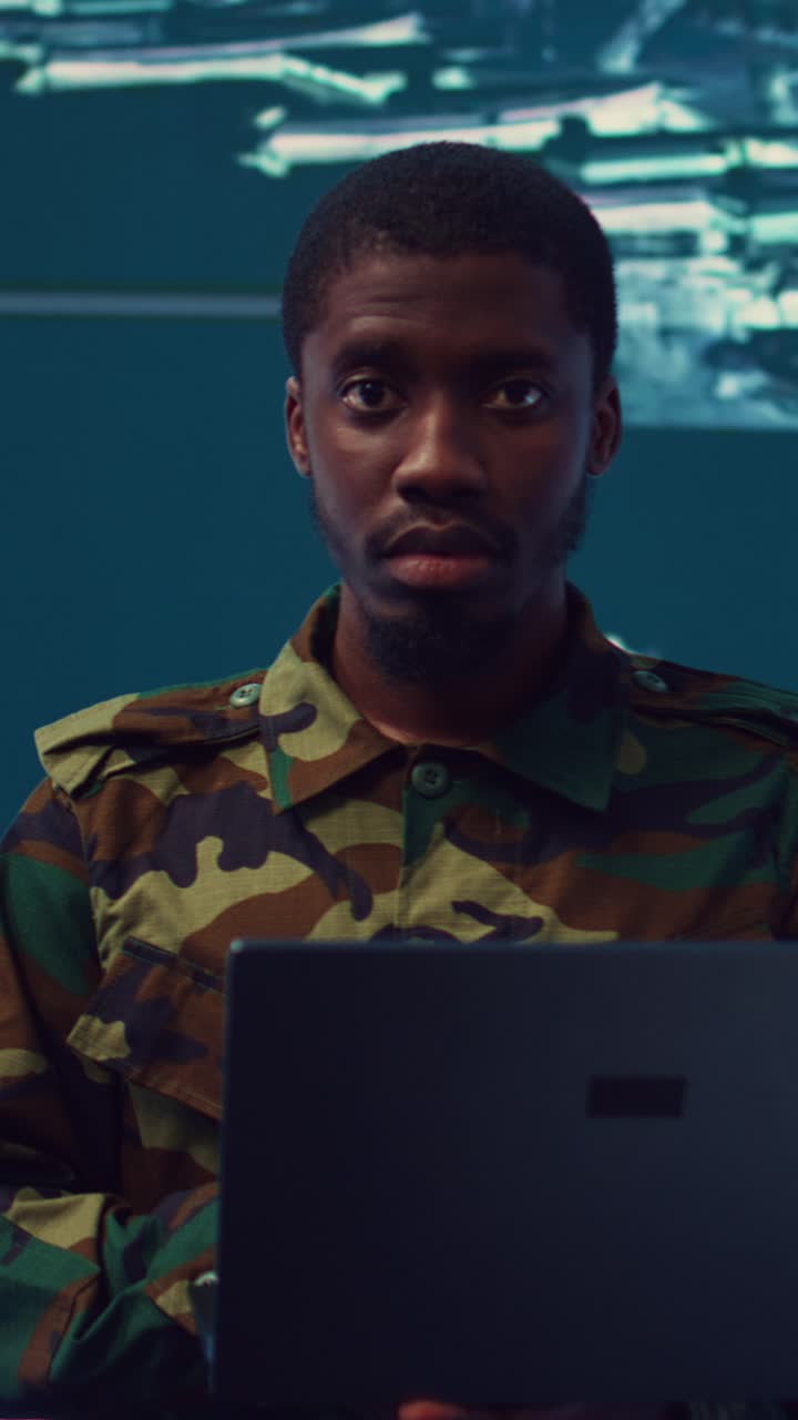 Soldier in Camouflage Uniform Working on Laptop in Control Room