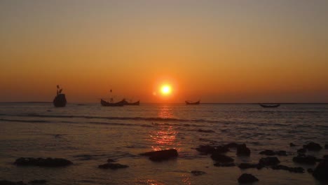 time lapse of low tides meeting the shoreline with sun setting in background