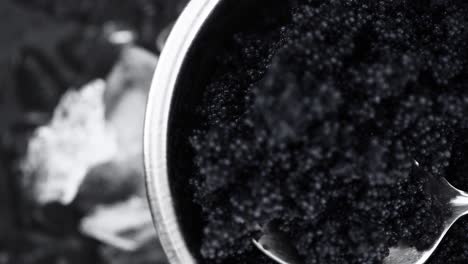 portion of black caviar rotating on a plate (close-up; seamless loopable)