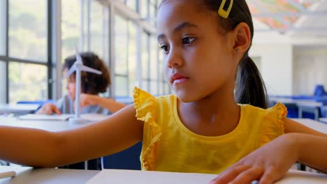 schoolgirl studying at desk in classroom 4k