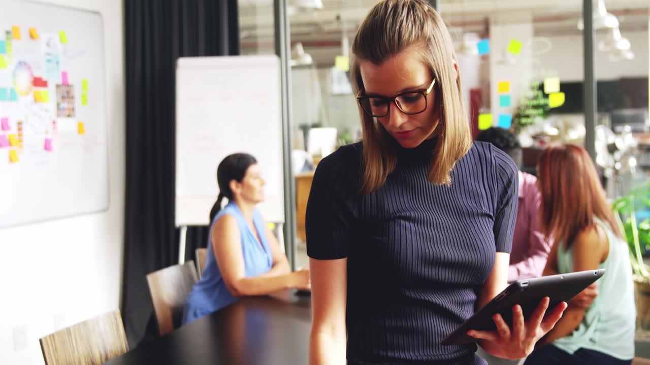 Business executive using mobile phone and digital tablet