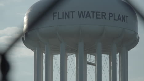 the camera title up to reveal the top of the flint water tower at the flint, michigan water plant