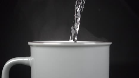 filling cup with hot water with vapour, slow motion 4k