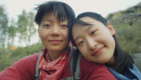 happy asian female couple on hike