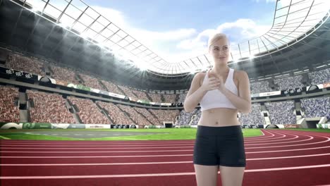 female athlete clapping hands in stadium