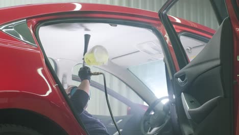 professional car cleaning. сar wash. interior detailing. dry clean and detail a car interior. deep seats cleaning. wiping foam in car wash. cleaning the car panel from dust. a vacuum cleaner