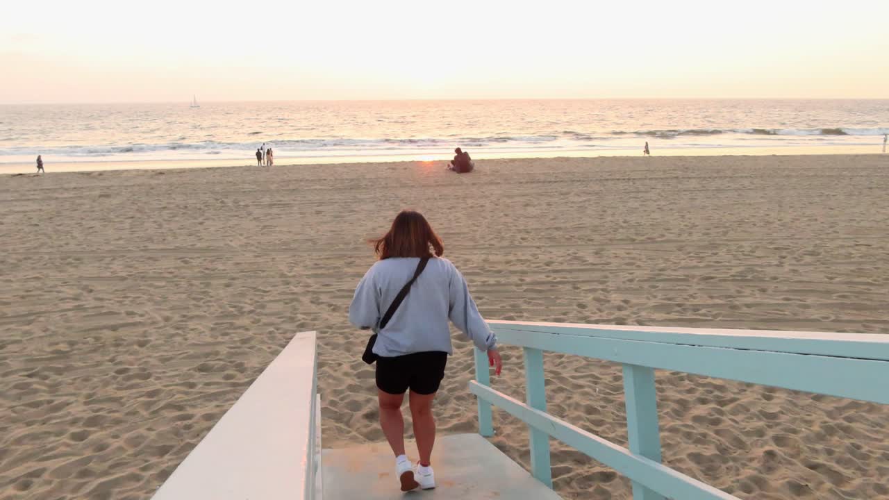 황금시간대에 해변을 걷는 소녀의 여행 영상