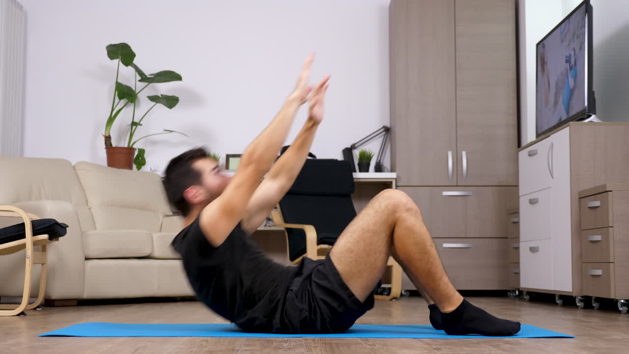 Man doing sit-ups in living room