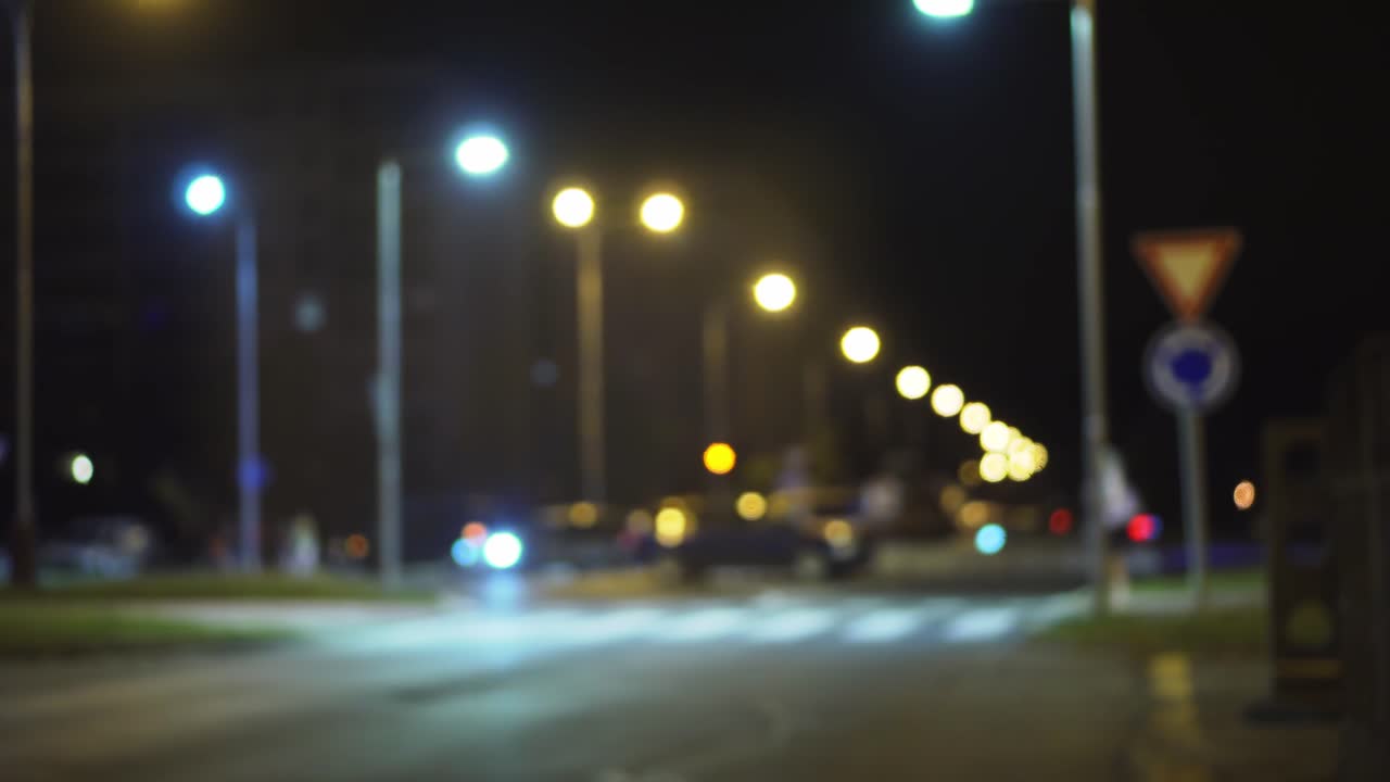 Car accident on roundabout in city, blurred blue police lights at night