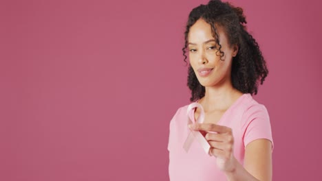 Video-of-smiling-biracial-woman-holding-white-lung-cancer-ribbon