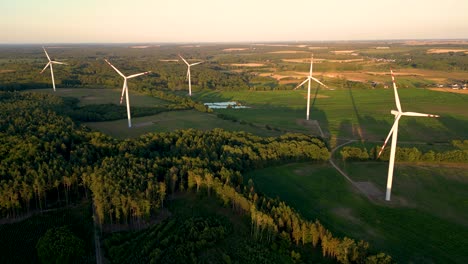 aerial view of windmills farm for energy production on beautiful cloudy sky at highland