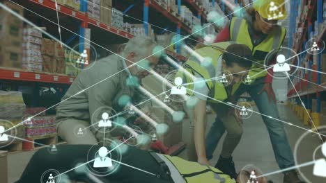 Animation-of-dna-helix,-connected-icons,-diverse-workers-assisting-unconscious-man-in-warehouse