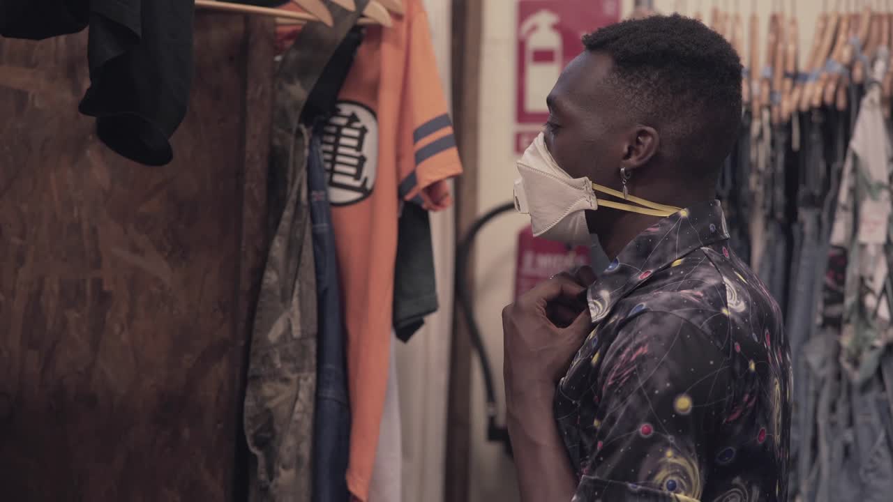 Man Wearing Mask in Clothing Store