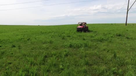 atv following horses and riders pan to lone atv riding in the same meadow, kansas