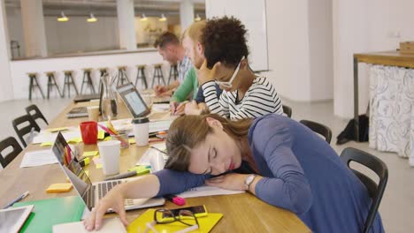 tired worker at table in office