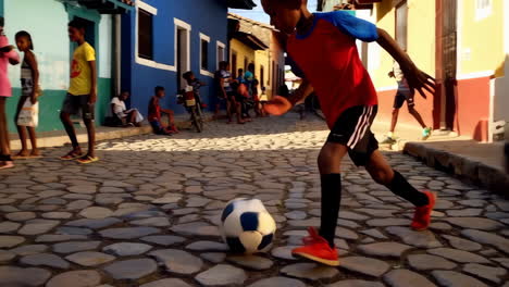 children playing soccer in a colorful cuban street