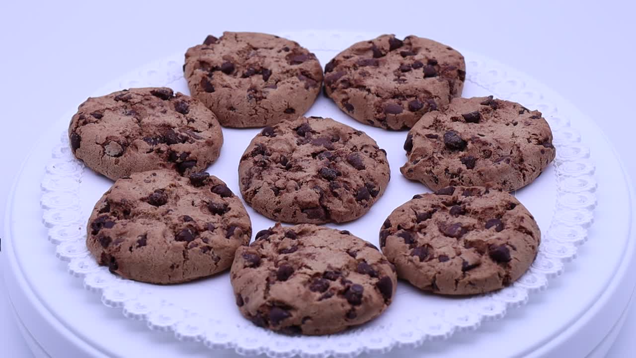 Cookies with chocolate chips rotating on a turntable