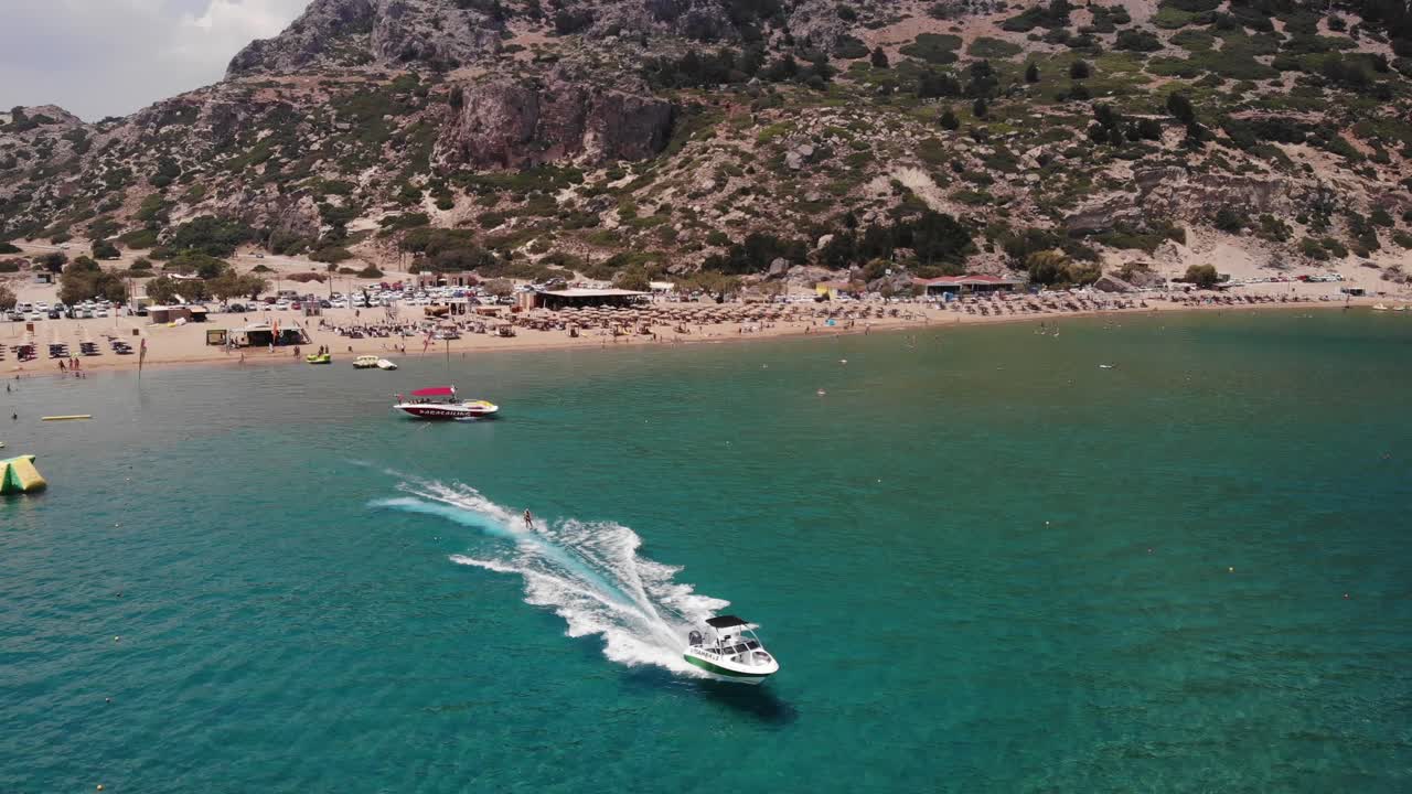 Wakeboarding - Wakeboarder Surfing On Wake Of Speedboat Cruising In The Sea In Tsambika Beach, Rhodes, Greece