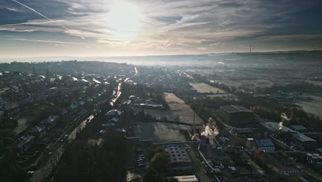 cold winter aerial footage of a town city landscape, with low afternoon lighting and freezing sunlit houses