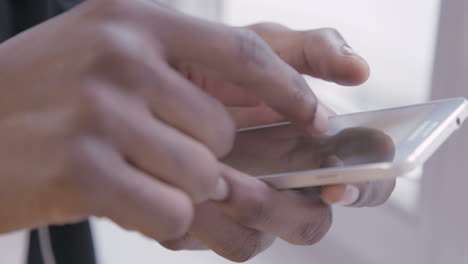 hands of african american man using mobile application