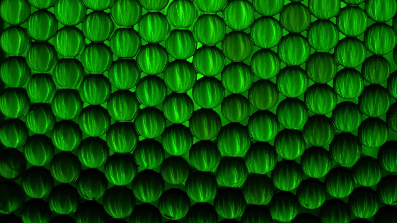 Mini tinted crysal globes reflecting colorful light pattens; loop