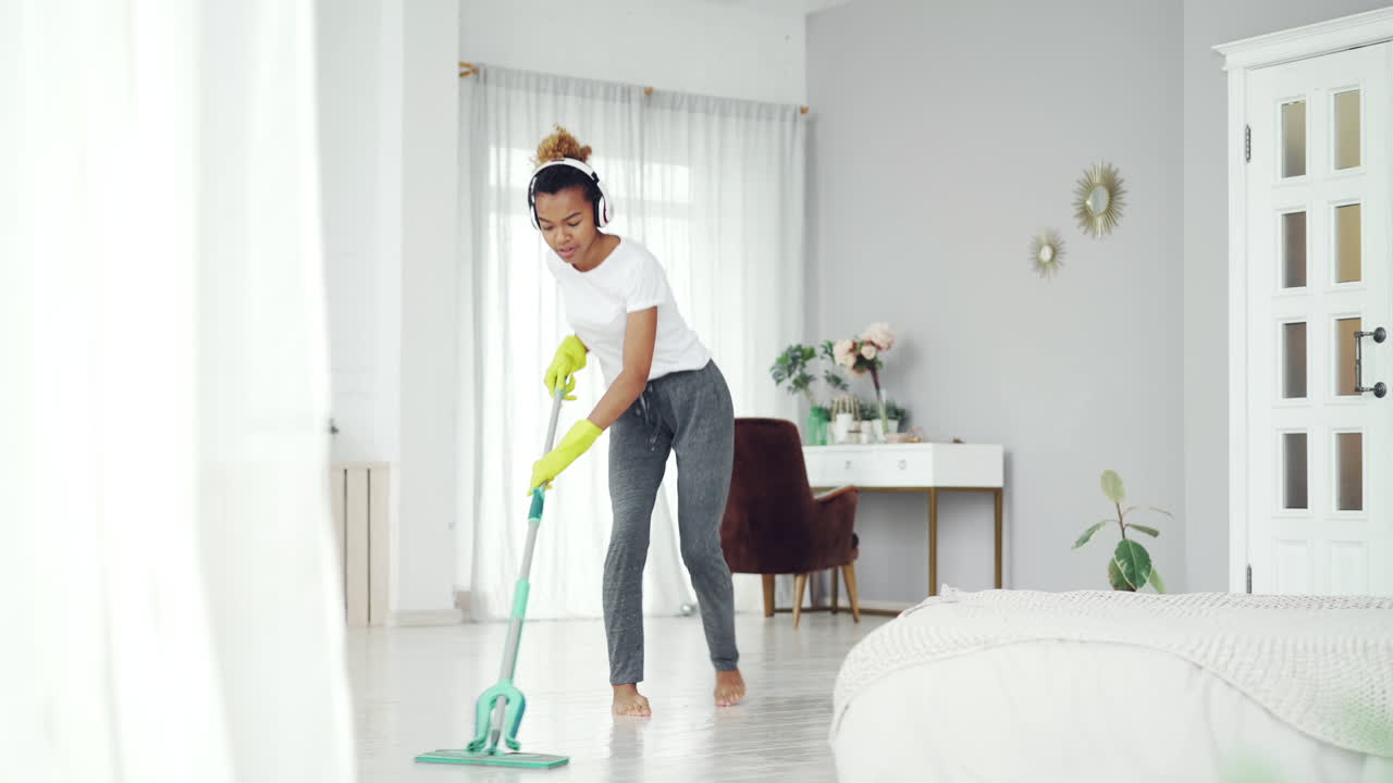 Woman Mopping the Bedroom Floor