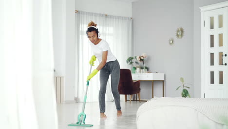 woman mopping the bedroom floor