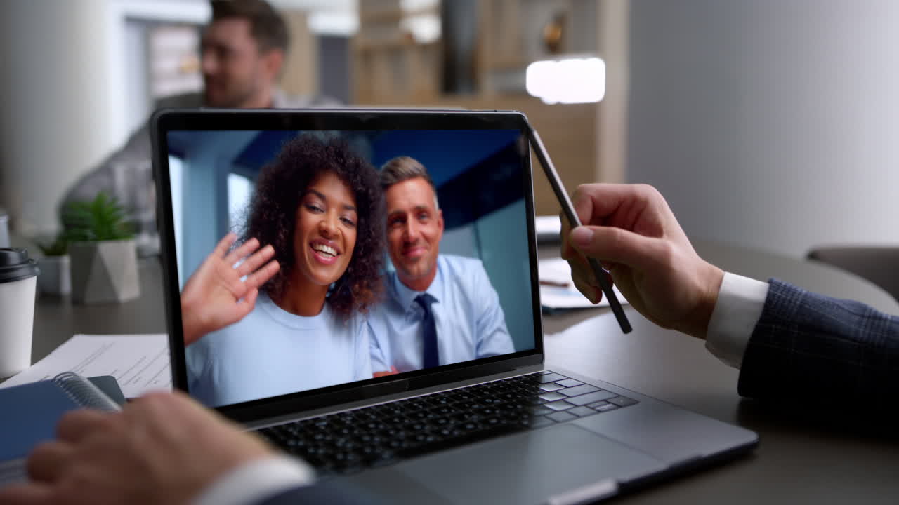 Multiethnic couple talking webcam conference with unrecognized manager close up