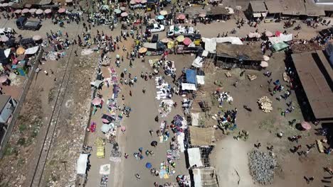 fly over an african market next to a railway