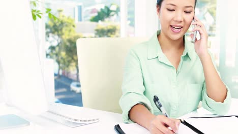 Asian-businesswoman-working-at-desk