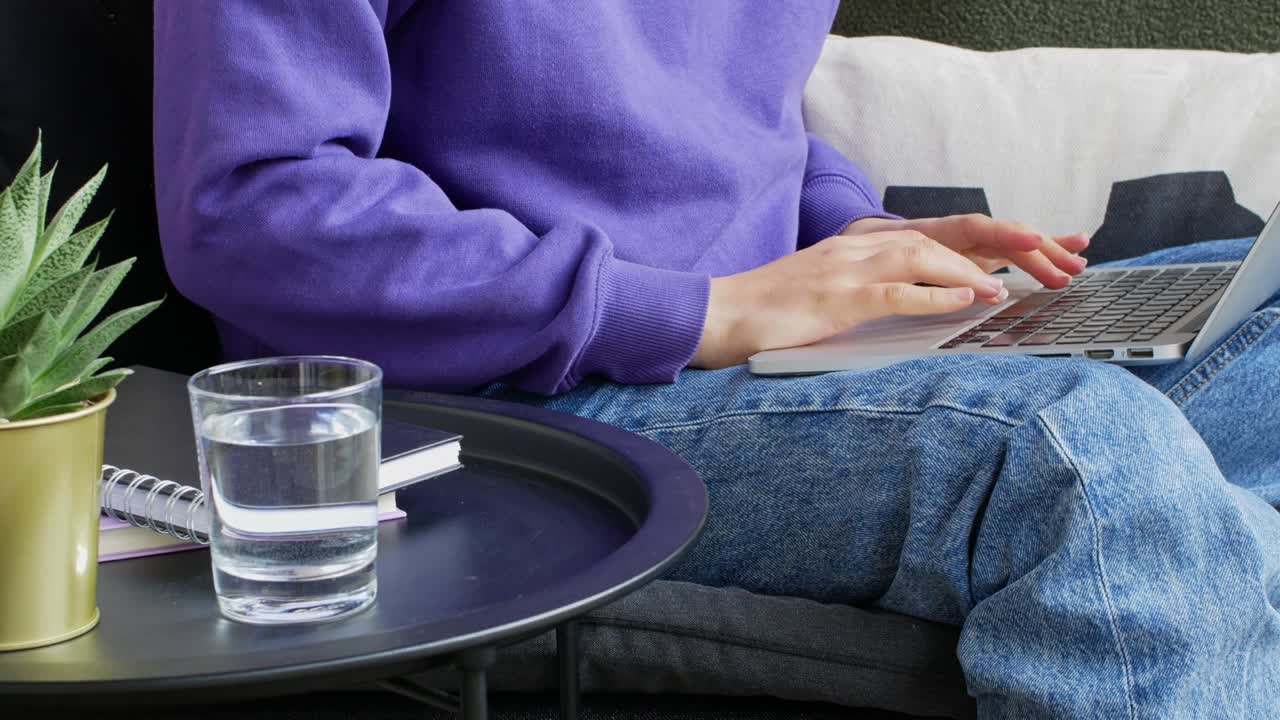 Woman sitting on the terrace working on her laptop.